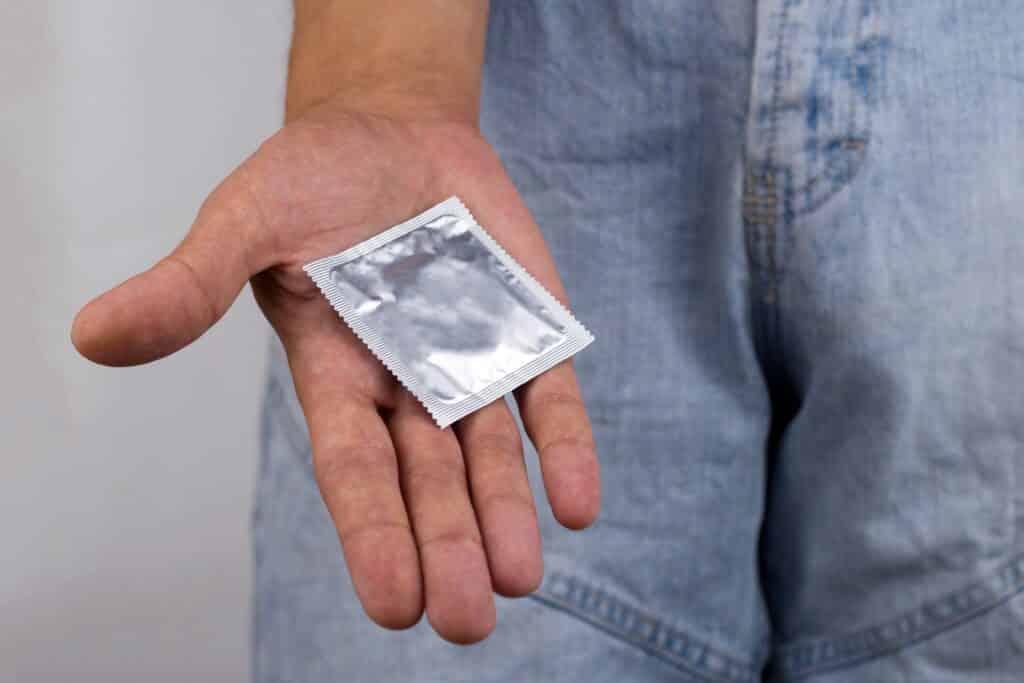 Man holding a condom