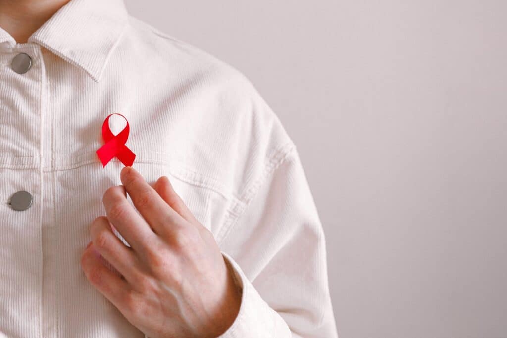 man wearing an HIV awareness ribbon